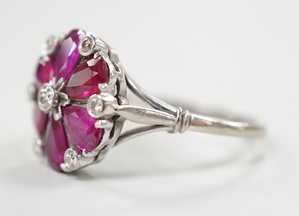 An 18ct & plat, pear cut ruby and diamond chip cluster set ring, size N/O, gross weight 4.8 grams.